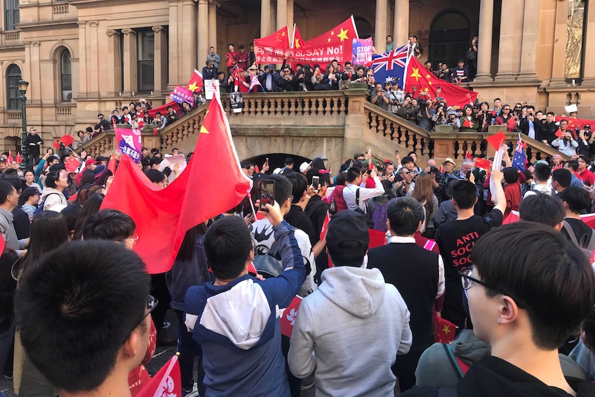 Protesters with Chinese flags gathered at Sydney Town Hall.