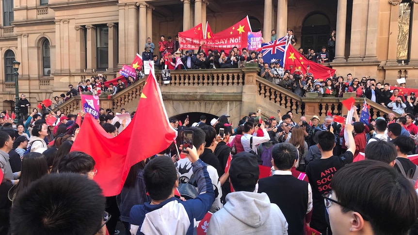 Protesters with Chinese flags gathered at Sydney Town Hall.