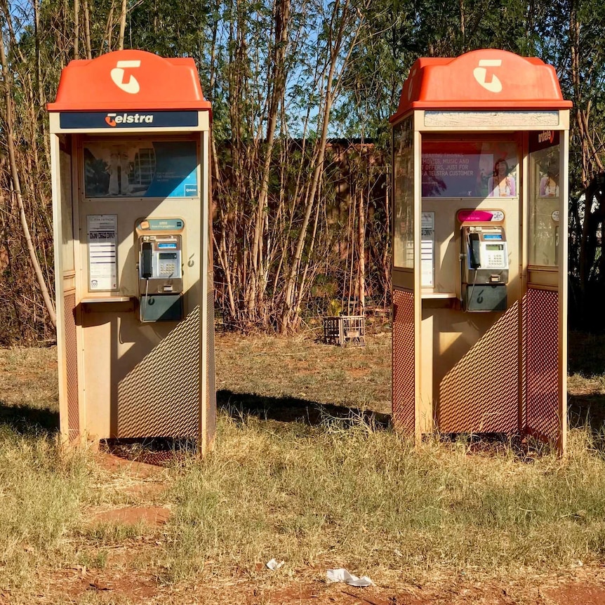 Image of two old phone boxes at a road house in northern Western Australia.