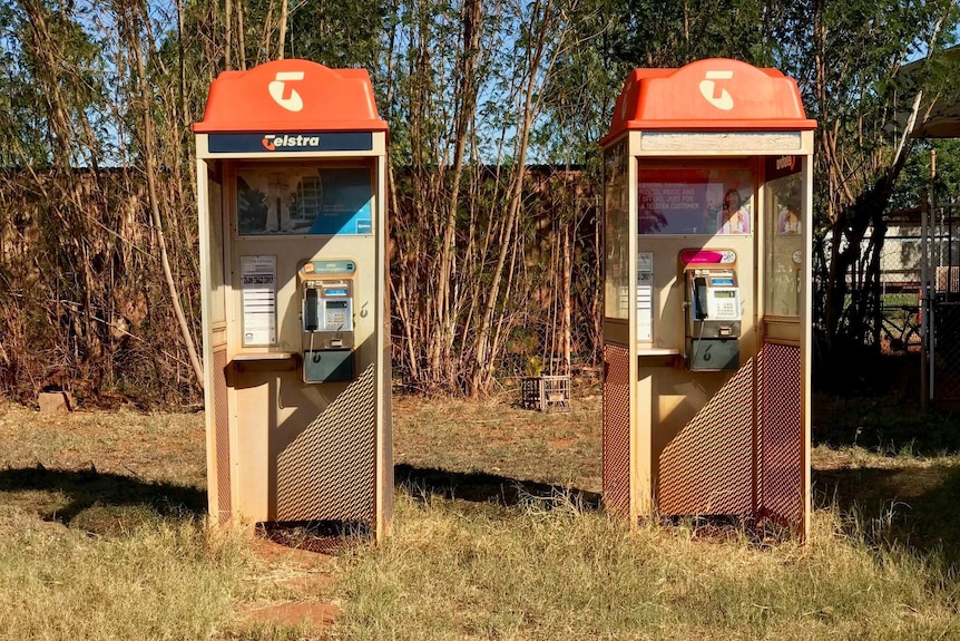 Image of two old phone boxes at a road house in northern Western Australia.