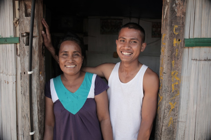 A man and woman stand in a doorway 