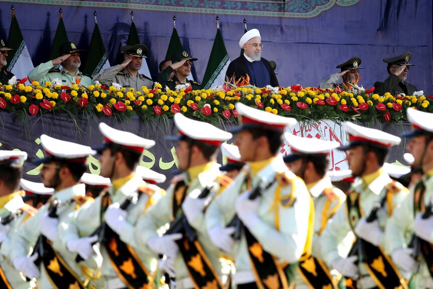 Iran's President Hassan Rouhani watches the military parade in Tehran