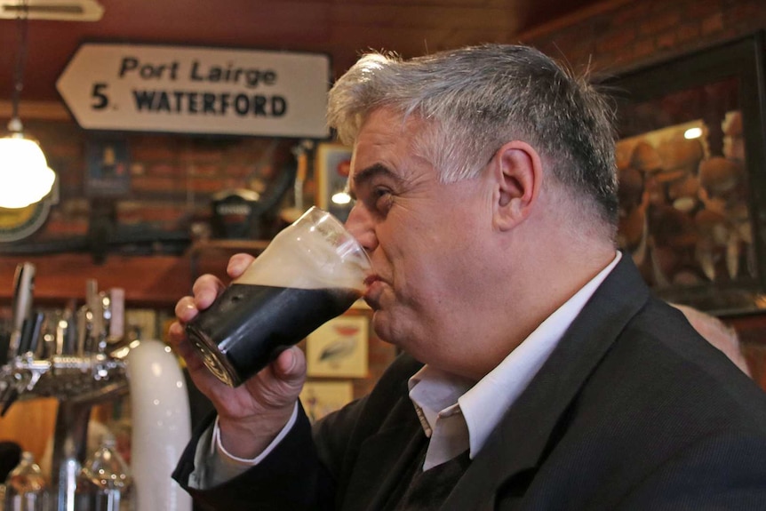 Brian Mitchell, Tasmanian politician, drinks a Guinness in an Irish pub.