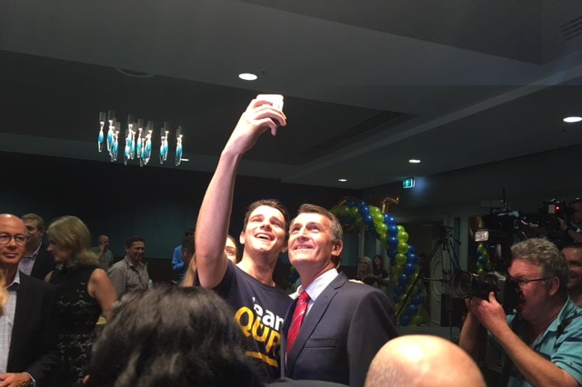 A Team Quirk supporter gets a selfie with Brisbane Lord Mayor Graham Quirk