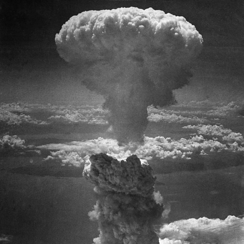 A black and white image of a huge mushroom cloud