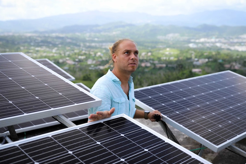 In his home town of Mariana, music professor Luis Rodriguez is installing solar panels on his roof.
