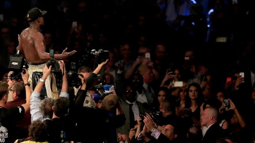 Floyd Mayweather signals to the crowd after win over Pacquiao