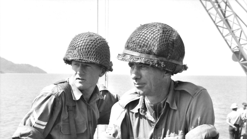 Men sitting on APC in Vietnam War Supplied Australian War memorial photo ID DNE/65/0112/VN