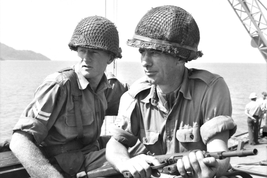 Men sitting on APC in Vietnam War Supplied Australian War memorial photo ID DNE/65/0112/VN