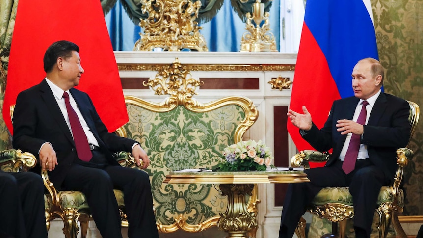 Russian President Vladimir Putin speaks with Chinese President Xi Jinping during a meeting in the Kremlin, in Moscow, Russia.