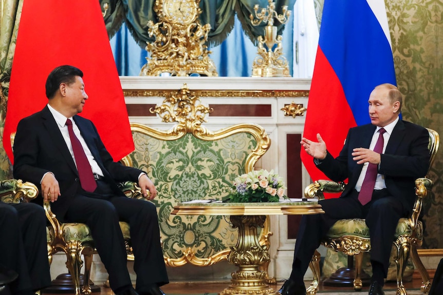 Russian President Vladimir Putin speaks with Chinese President Xi Jinping during a meeting in the Kremlin, in Moscow, Russia.