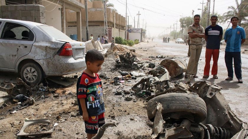 Iraqis gather at the site of a blast in Fallujah on August 8, 2010.