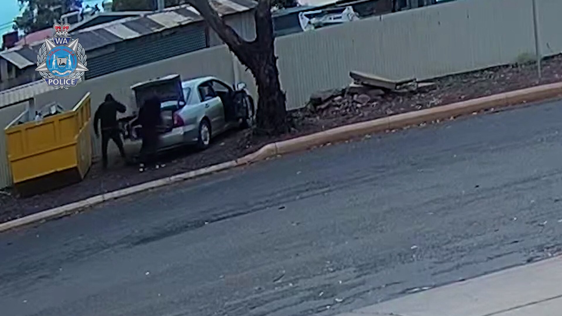 Two men captured on CCTV loading allegedly stolen property into a car boot. 