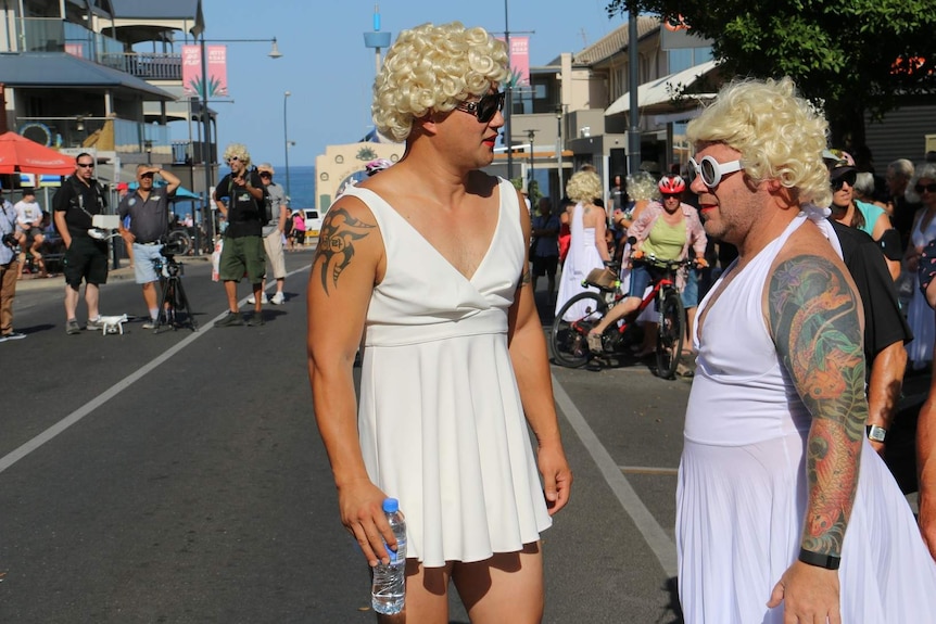 Two men dressed as Marilyn Monroe in a street