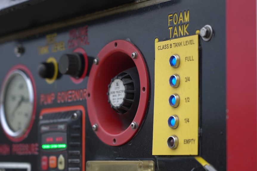 Close up of buttons and features of a fire truck showing the words 'foam tank'