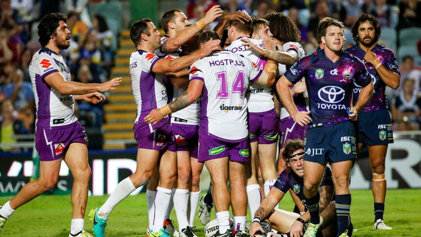 Melbourne Storm celebrate a try against North Queensland