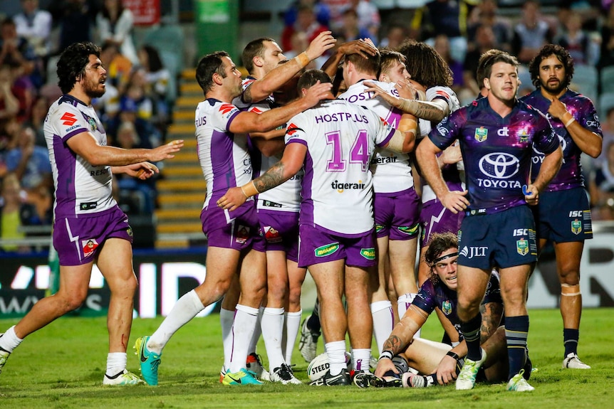 Melbourne Storm celebrate a try against North Queensland