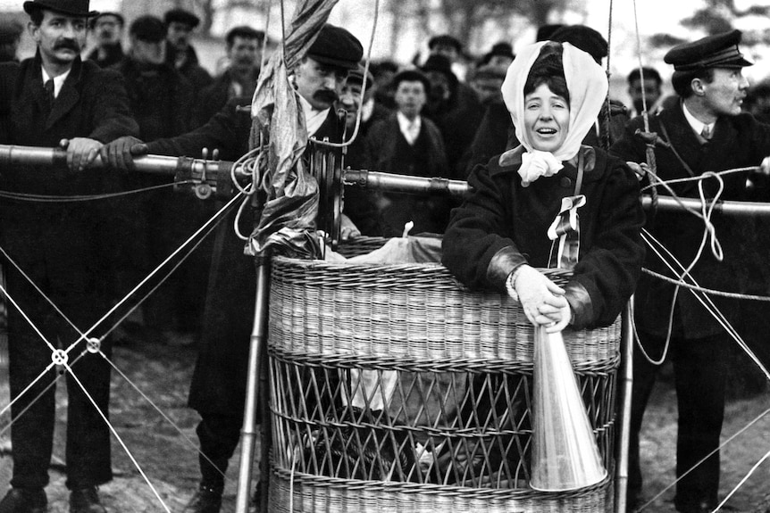 Woman holds a megaphone inside an airship