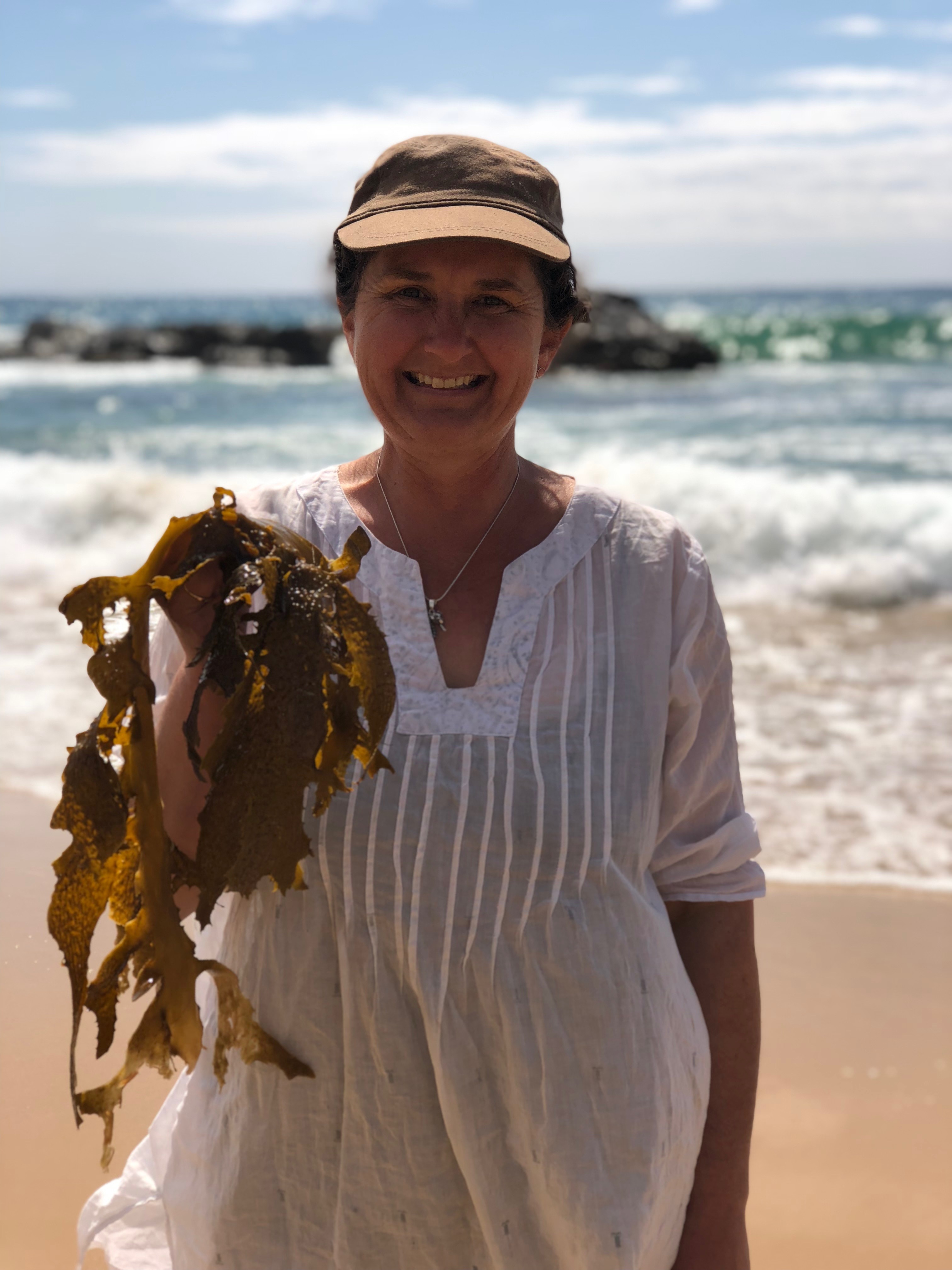 A women with kelp on beach