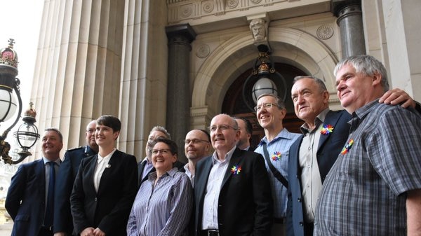 Gay rights activists gather on the steps of Victoria's Parliament