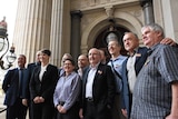 Gay rights activists gather on the steps of Victoria's Parliament