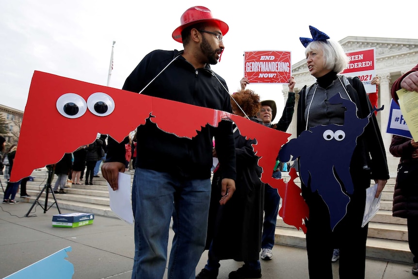 Protesters with congressional district cut-outs around their necks