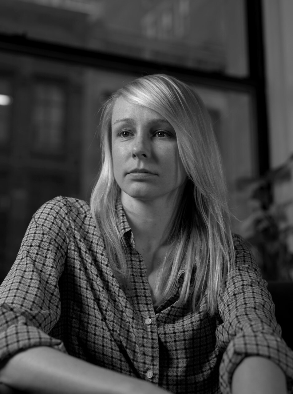 A black and white portrait of Kitty Green, who has long blonde hair.