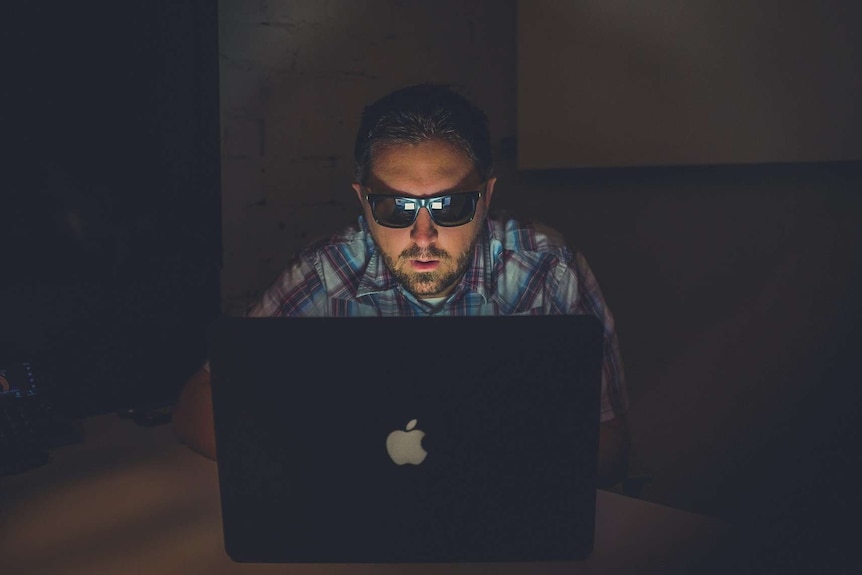 Man in the dark working on computer