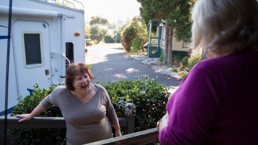 Helen Smith laughs on neighbour Judy Battersby's porch.