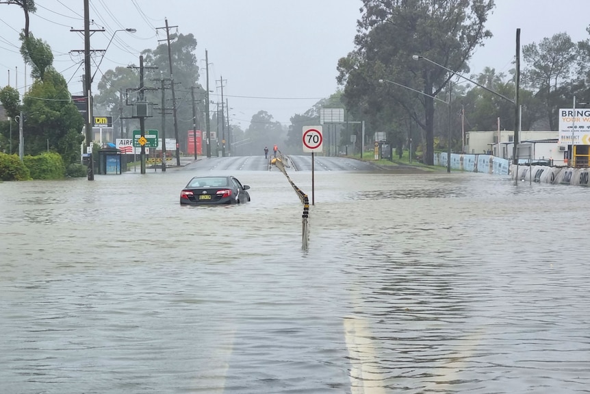 a car stuck in floodwaters