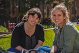 Nalyn Sirivivatnanon and mentor Emma Tulich sit on the grass at Sydney University