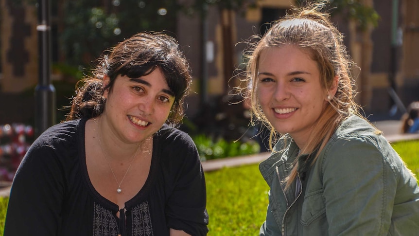 Nalyn Sirivivatnanon and mentor Emma Tulich sit on the grass at Sydney University