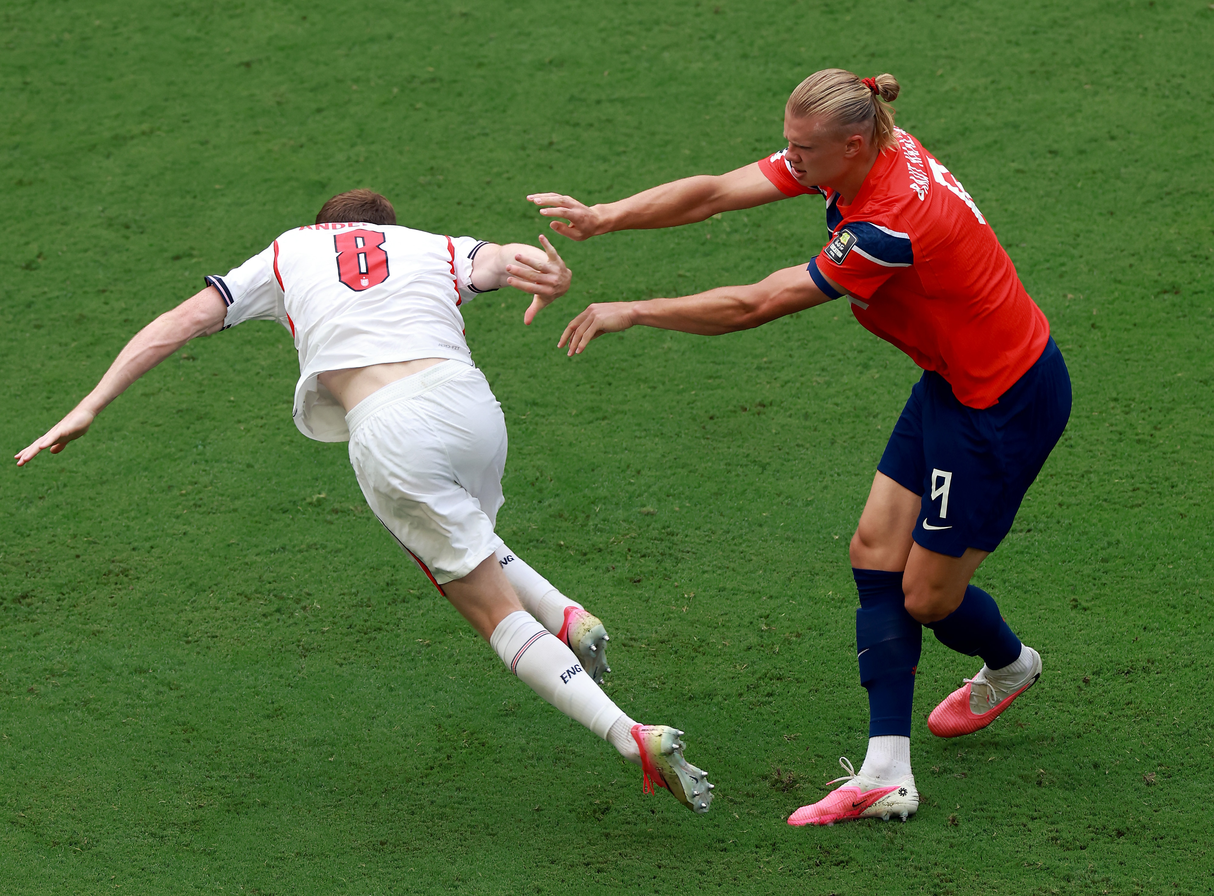 Erling Haaland pushes Elliot Anderson with two hands.