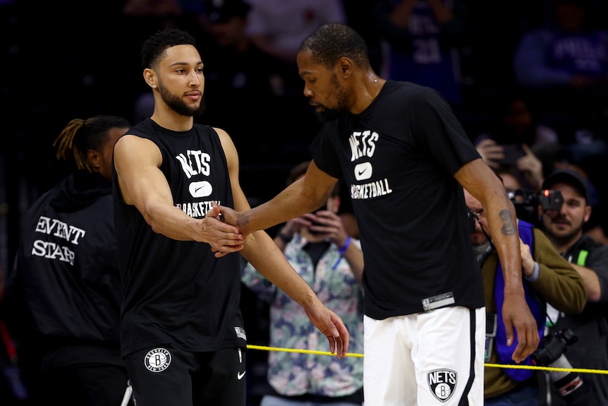 Brooklyn Nets NBA teammates Ben Simmons and Kevin Durant high five before a game against the Philadelphia 76ers.