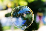 House reflected in soap bubble