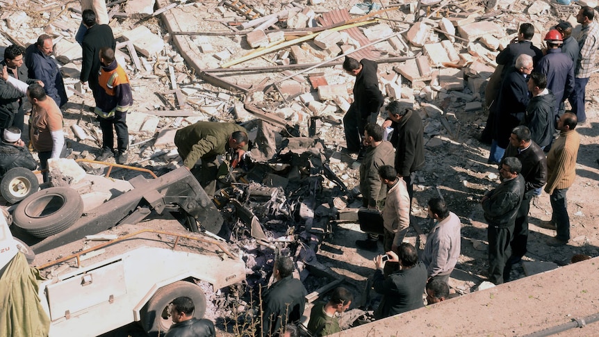 Syrian inspect bomb damage in Aleppo