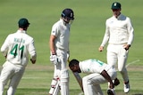 South Africa bowler Kagiso Rabada shouts at the ground while standing next to England batsman Joe Root.