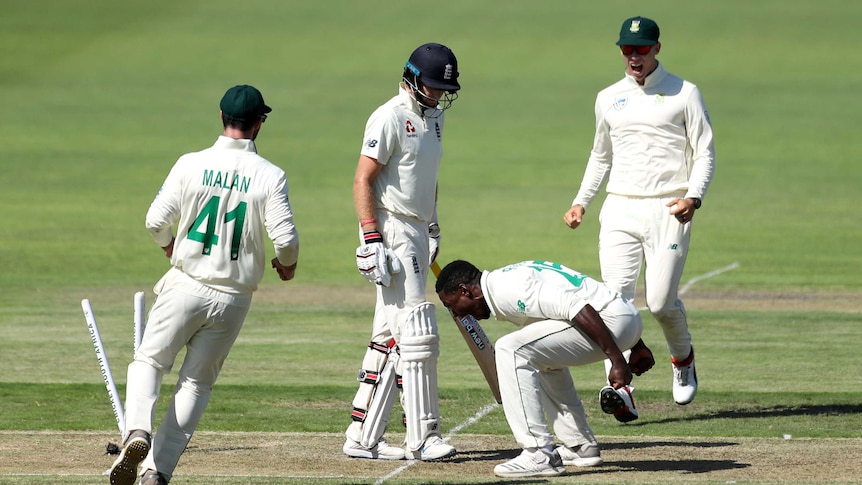 South Africa bowler Kagiso Rabada shouts at the ground while standing next to England batsman Joe Root.