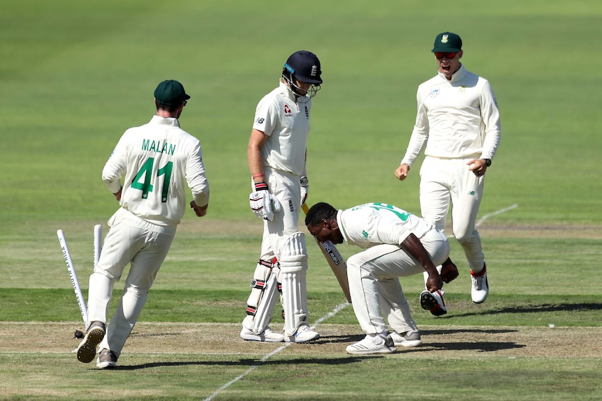 South Africa bowler Kagiso Rabada shouts at the ground while standing next to England batsman Joe Root.