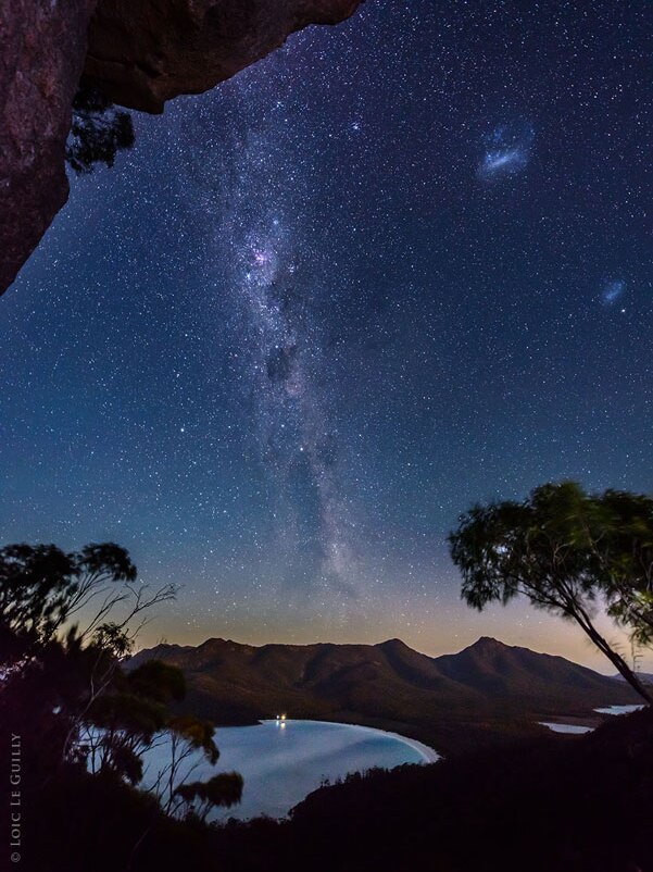 Wineglass Bay and the  Milky Way in the night sky.