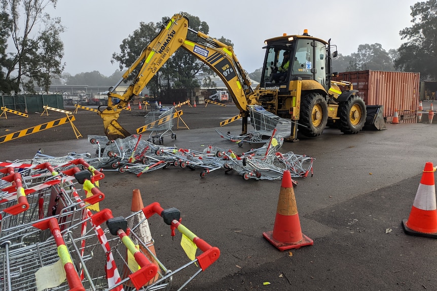 Shopping trolleys destroyed by a digger