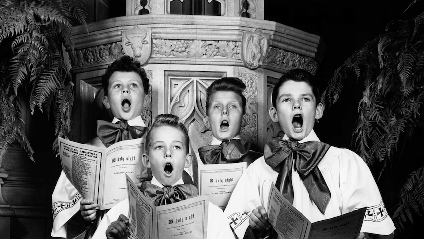 Black and white image of four choir boys
