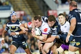 Timothy Glasby of the Storm is tackled by Gavin Cooper of the Cowboys in Townsville on May 25, 2018.