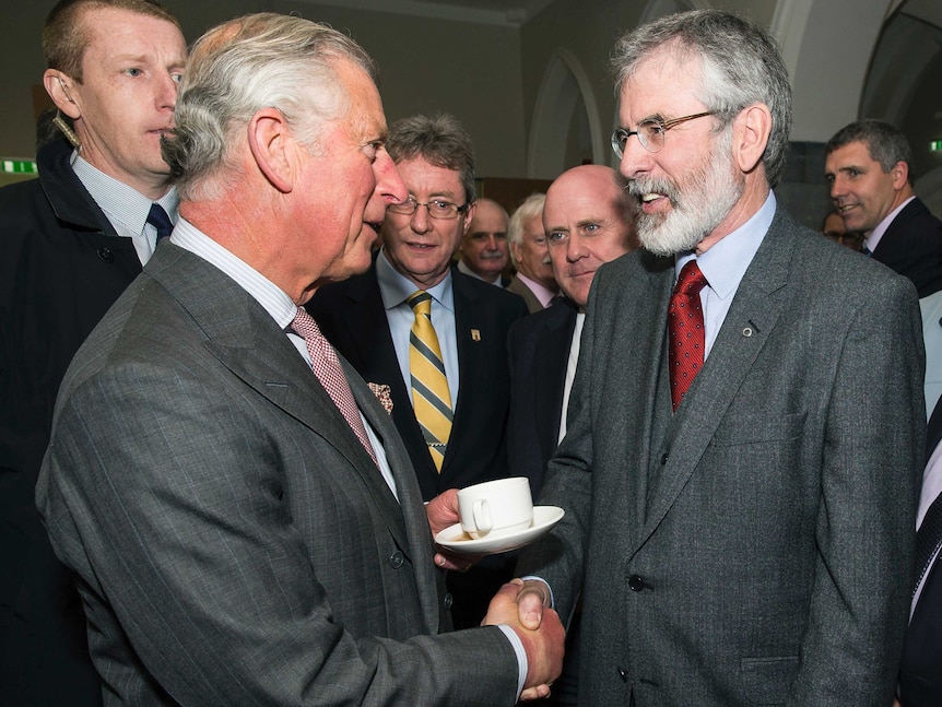 Prince Charles shakes hands with Gerry Adams