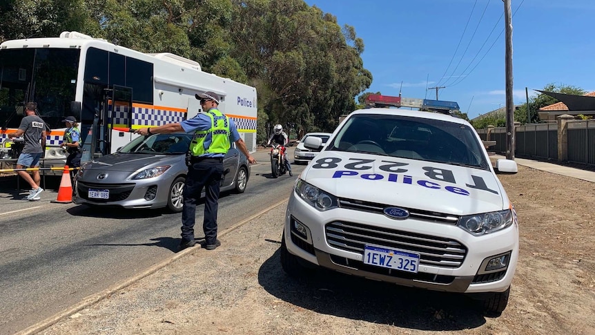 Police direct drivers into a drug testing van.