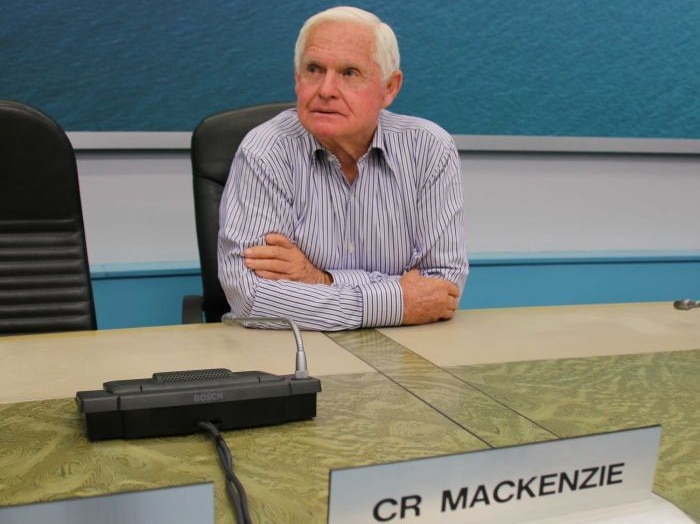 Picture of Mayor Bruce MacKenzie sitting at a desk at Port Stephens Council.