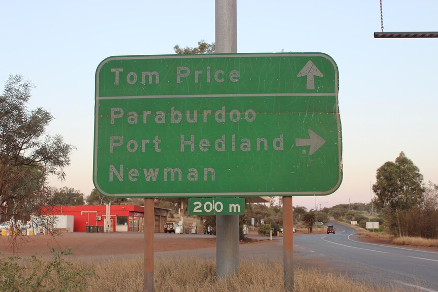 A dusty road sign in the Pilbara.