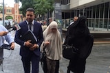Sameh Bayda's lawyer Fadi Abbas with two women supporters outside Parramatta Bail Court.