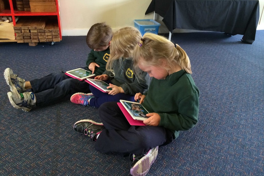 Three school children use the George the Farmer app