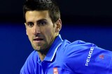 Djokovic charges down Muller's shot